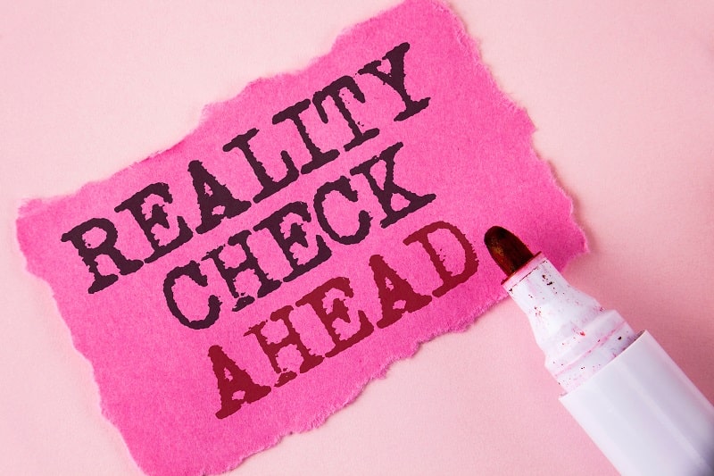 a graphic with the words reality check ahead